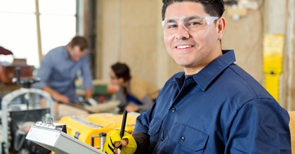 Manager of machine shop smiling while check customer orders