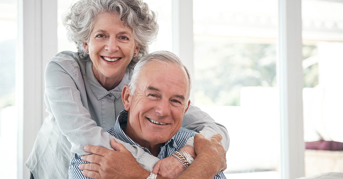 portrait of mature couple smiling in their home