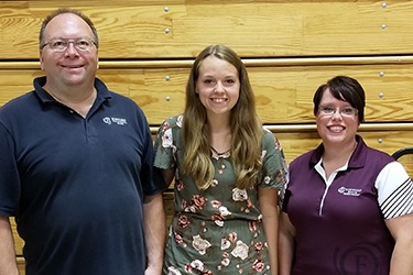 Mike Henke and Andrea Hazard from Forward Bank present Carlie Nelson of Stanley-Boyd High School with $500 scholarship.