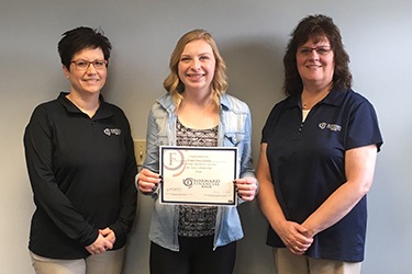 Traci Geiger and Vicky Fischer from Forward Bank presents Alyssa Faye Schade from Colby High School with $500 scholarship.