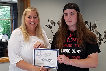 Sara Blume from Forward Bank presents Andrew Jankowsk from Owen-Withee High School with $500 scholarship.