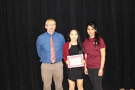 Gary Schraufnagel and Jessica Lopez from Forward Bank present Maria Palacios from Abbotsford High School with $500 scholarship.