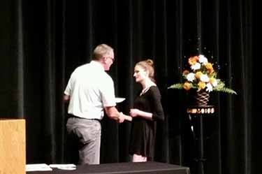 Dave Krause from Forward Bank presents Claire Greenlee from Marshfield High School with $500 scholarship.