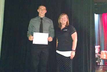 Molly Knoll from Forward Bank presents Benjamin Meier from Medford High School with $500 scholarship.