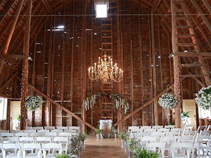 inside wooden barn decorated for wedding
