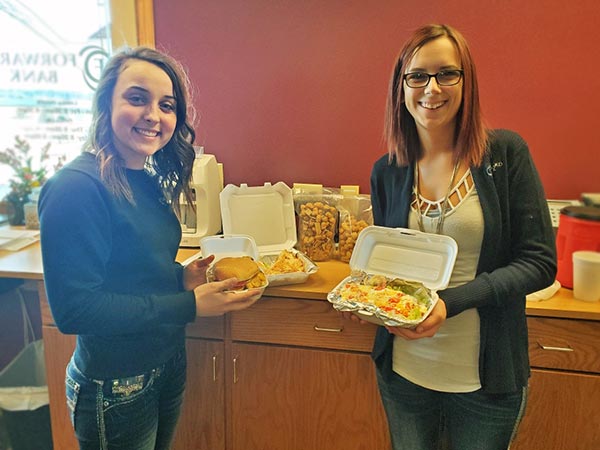 Two Forward Bank employees enjoying lunch for Thoughtful Thursday in Phillips, WI