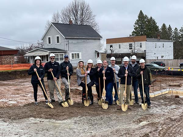 Group of Forward employees and contractors stand with shovels at the groundbreaking of the new office building in Athens, WI.