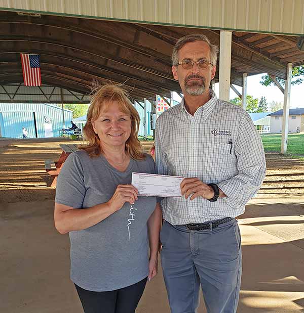 Jenny Lipinski receives donation on behalf of Athens Acres 4-H from Glen Luetschwager.
