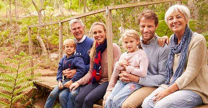 multi-generation family portrait on a bridge in forest