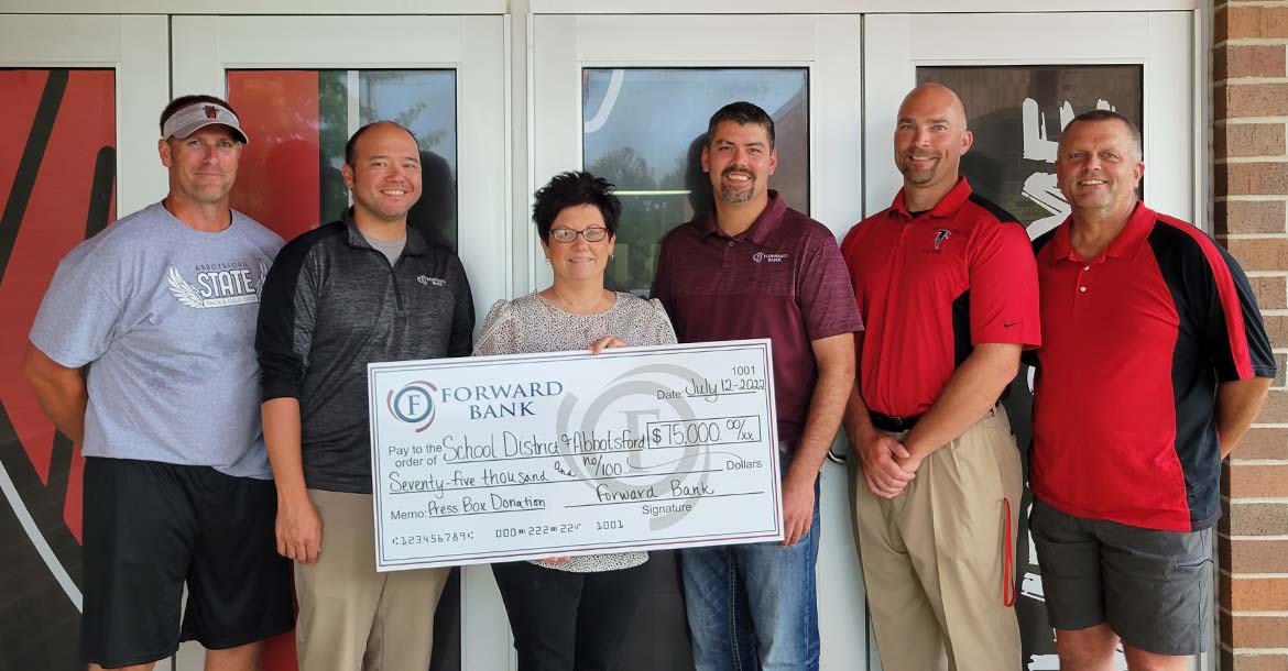 Forward Bank employees present the Abbotsford School District with $75,000 donation to update the football field's media booth.