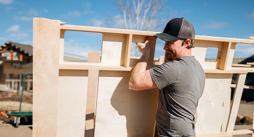Contractor preparing construction materials at a job site, representing small business growth and equipment investment before applying for a business loan.