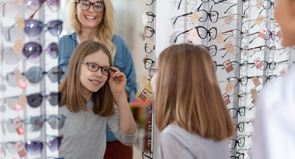Young girl getting new glasses with HSA funds.
